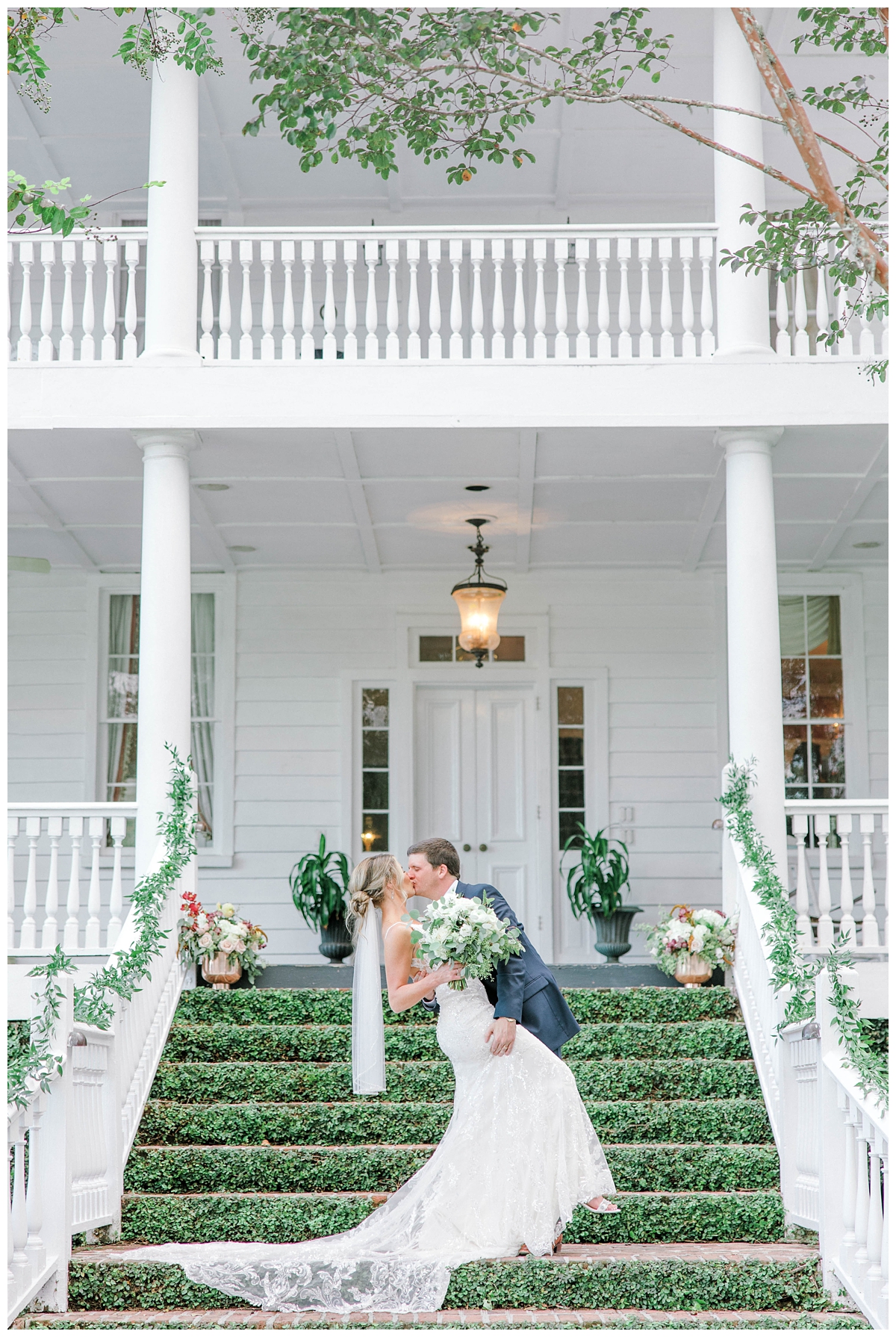 groom kisses bride dipping her on mossy steps at Old Wide Awake in Charleston SC