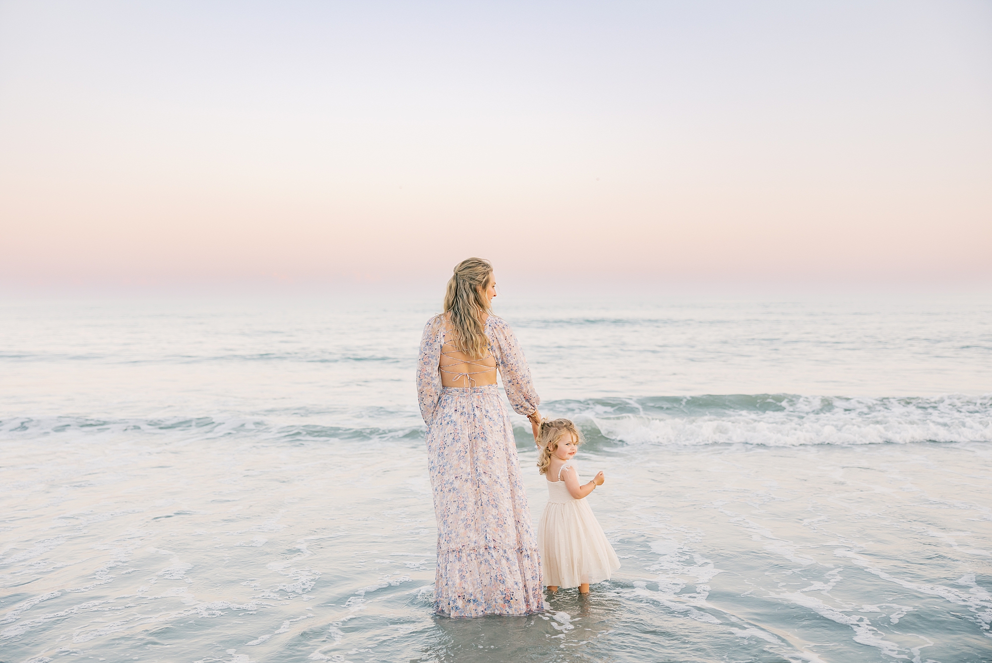 mom stands with toddler on beach during Charleston beach family photos