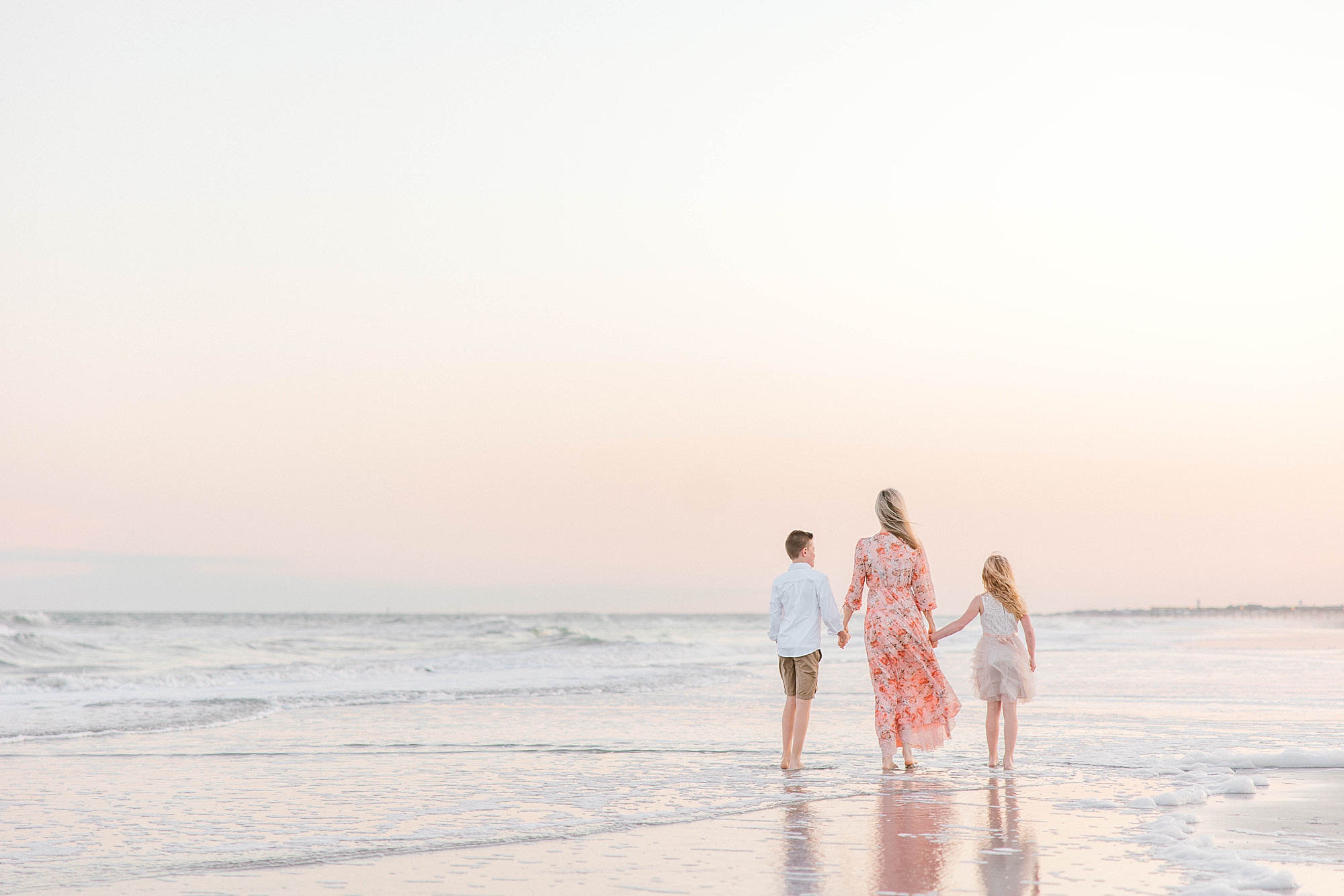 kids hold hands during sunset Charleston beach family photos