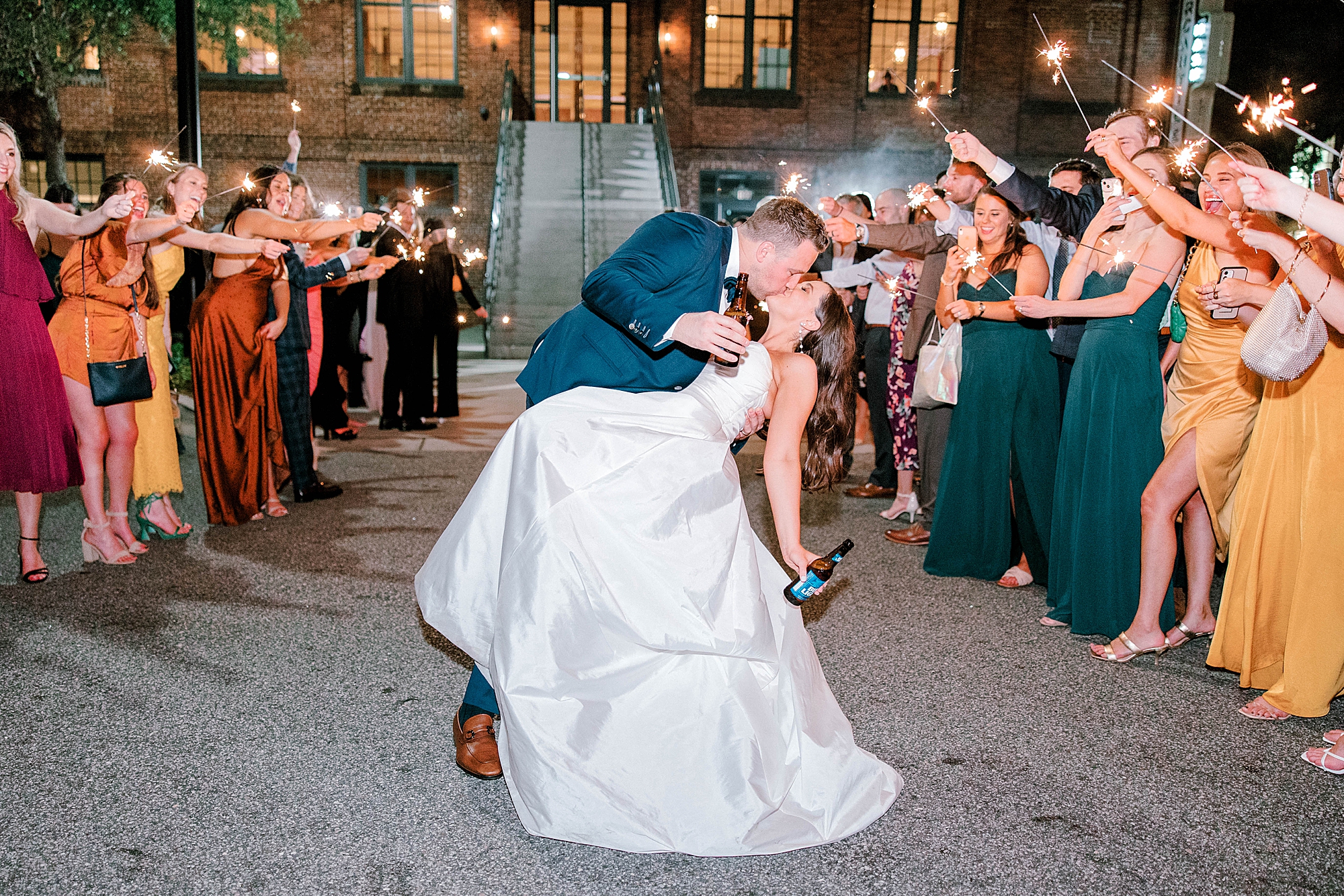 bride and groom kiss during sparkler exit 