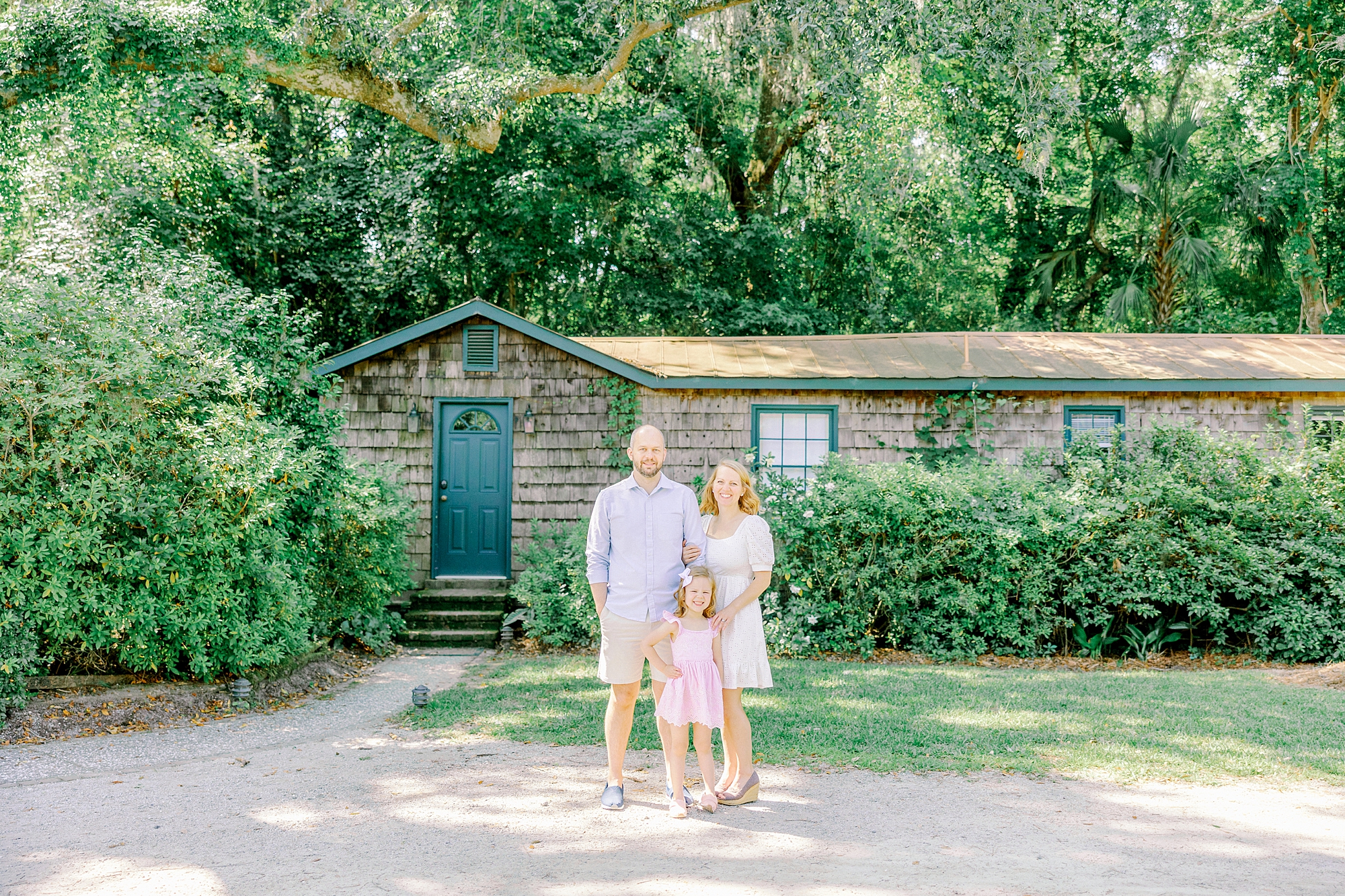 couple poses with young daughter during Charleston family photos