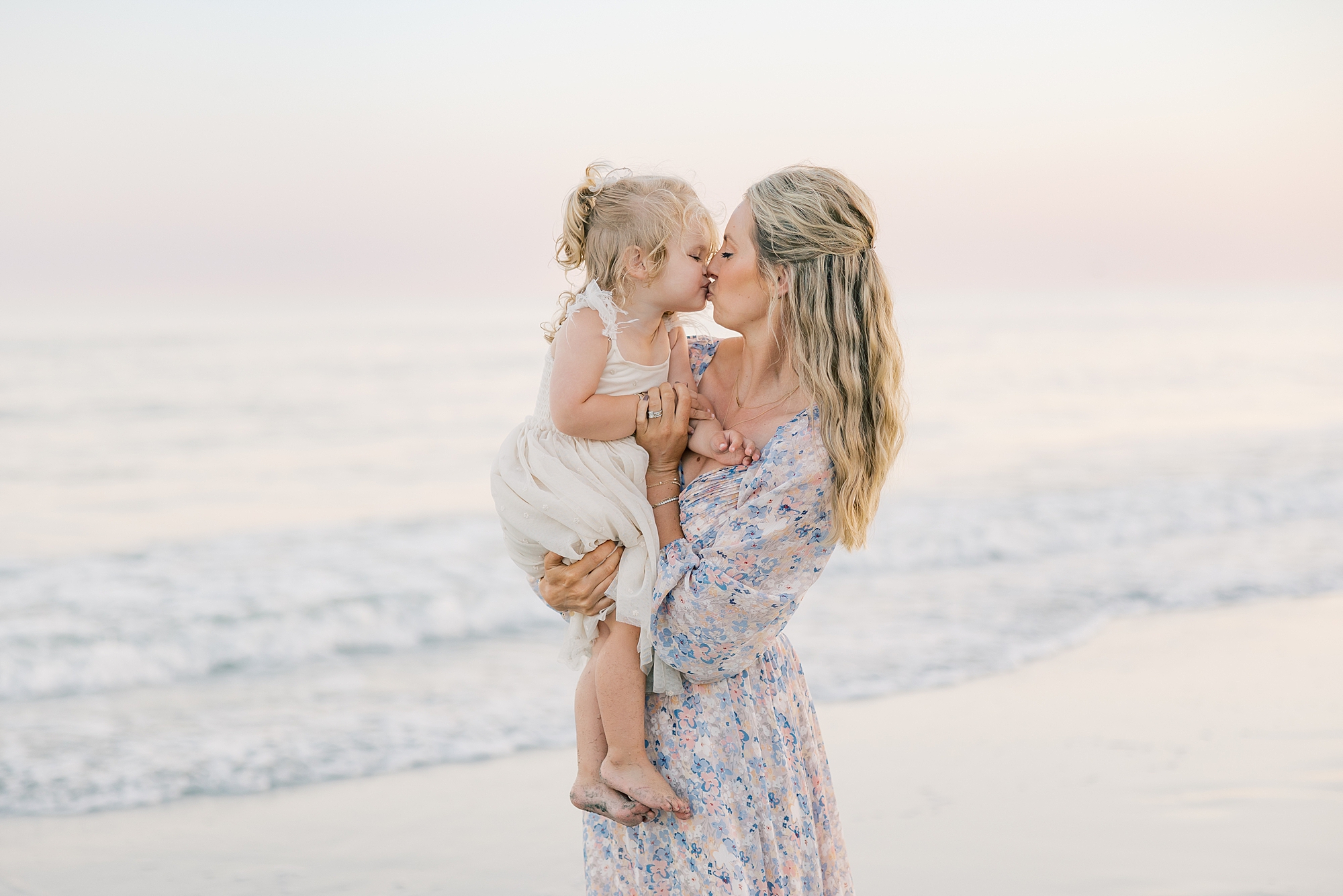 mom and toddler kiss on beach in South Carolina
