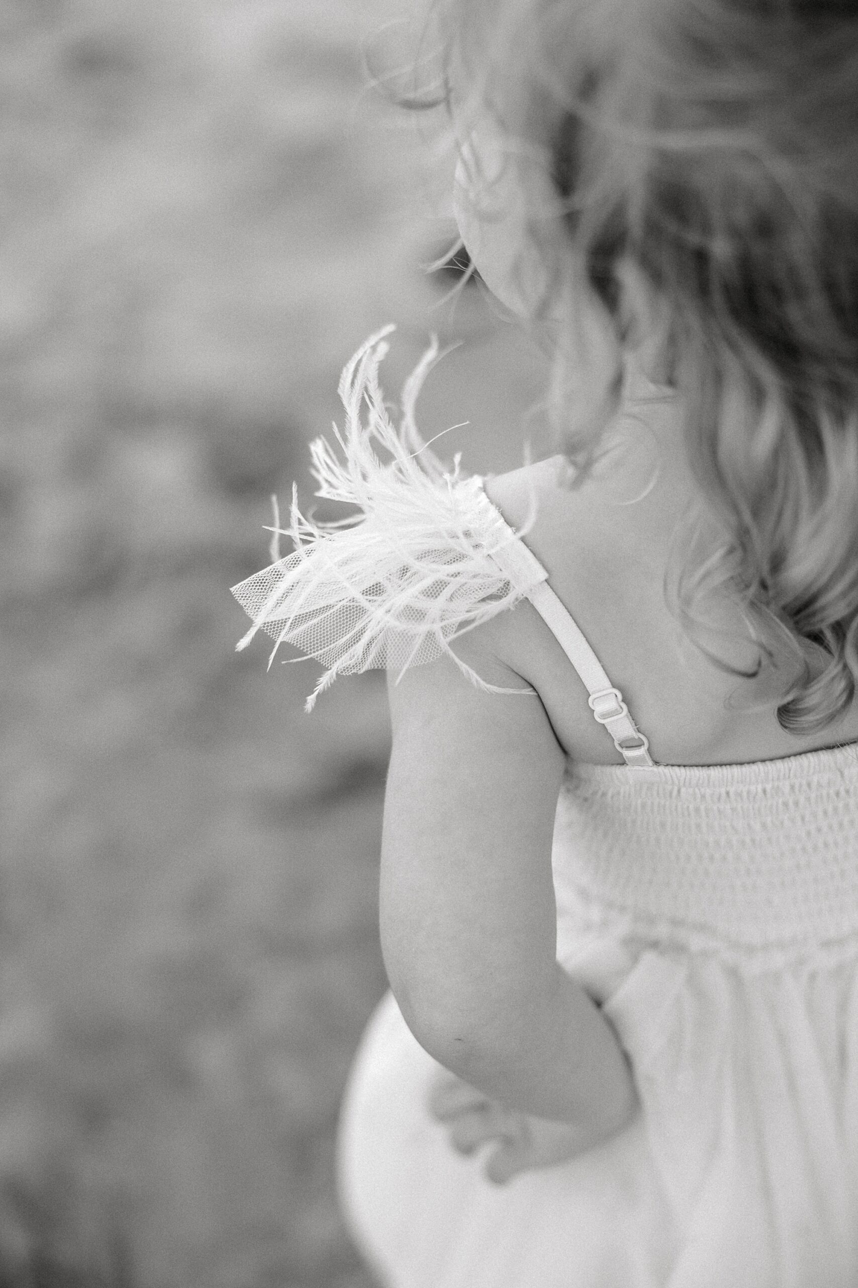 feather detailing on toddler's dress for Folly Beach family portraits